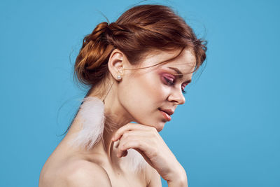 Young woman against blue background