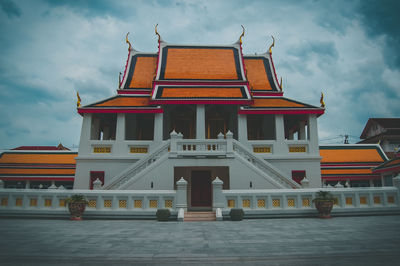 Facade of historic building against cloudy sky