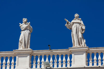 Low angle view of statue against clear blue sky