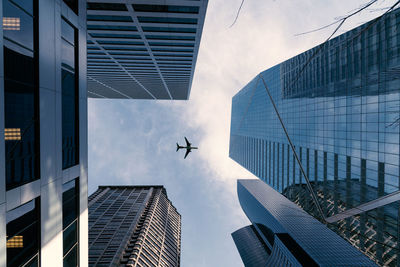 Low angle view of modern skyscrapers against sky