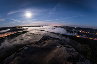 Scenic view of landscape against sky at night