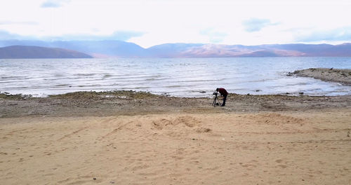 People on beach against sky