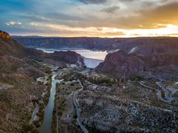 Scenic view of river against sky during sunset