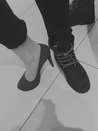 Low section of woman standing on tiled floor