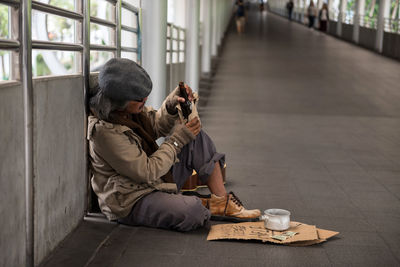 Homeless man sitting on street