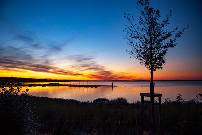 Scenic view of lake against sky during sunset