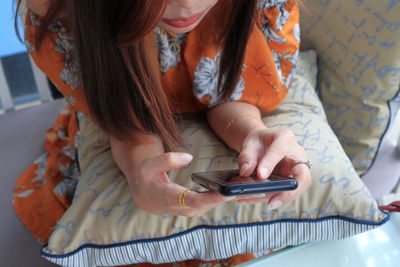 Midsection of woman using mobile phone