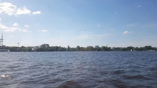 Scenic view of sea by buildings against sky