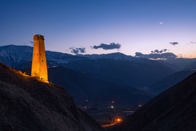 Scenic view of snowcapped mountains against sky at night