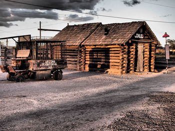 Road by buildings against sky in city