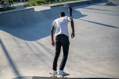 Rear view of man skateboarding