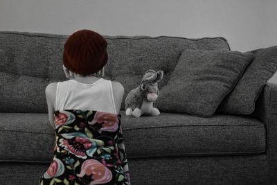 Girl sitting on sofa at home