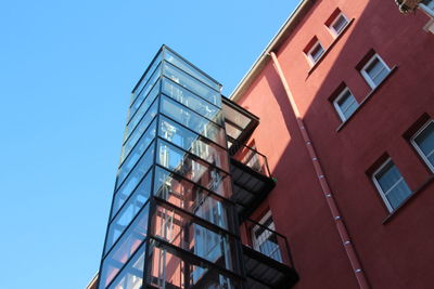 Low angle view of elevator of red building against sky