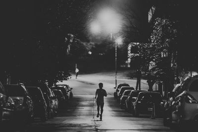 Rear view of people walking on street in city