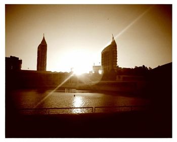 Skyscrapers in city at sunset