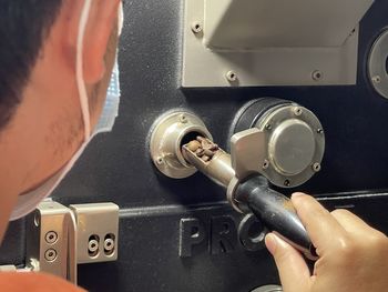 Close-up of man working on machine