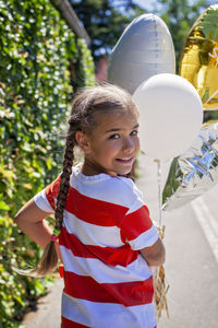 Rear view of woman with balloons