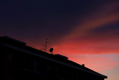 Low angle view of silhouette building against sky during sunset