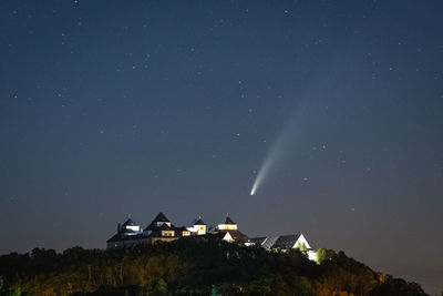 Houses against sky at night