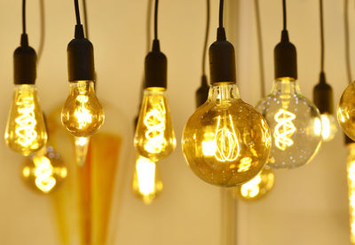 Close-up of illuminated light bulbs hanging