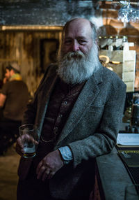 Portrait of mature men holding glass