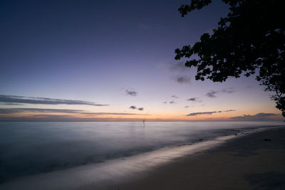 Scenic view of beach against sky during sunset