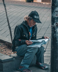 Full length of a man sitting outdoors