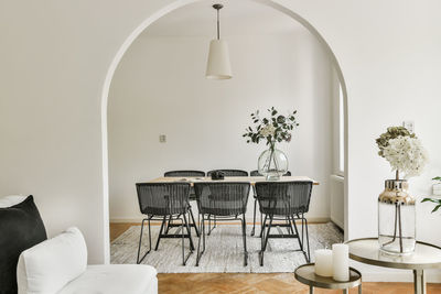 Empty chairs and table against white wall at home