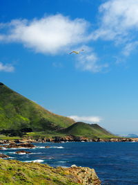 Scenic view of sea against cloudy sky