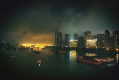 Illuminated cityscape against sky at night