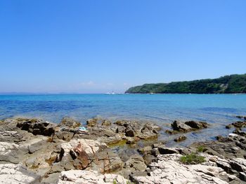 Scenic view of sea against clear blue sky