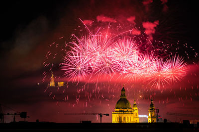 Low angle view of firework display at night