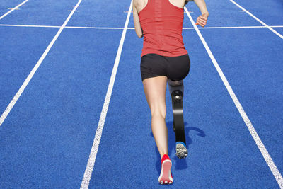 Low section of woman running