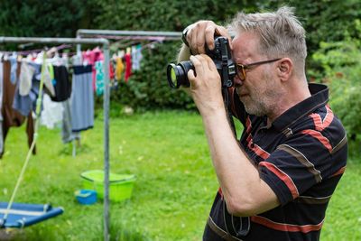 Side view of man photographing