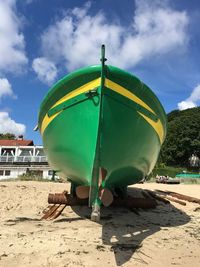 Multi colored umbrella on beach against sky