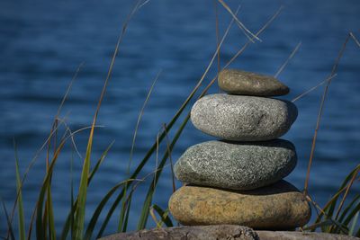 Close-up of stone stack on rock at sea shore