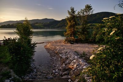 Scenic view of lake against sky during sunset