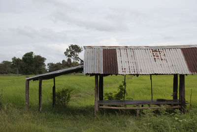 Built structure on field against sky