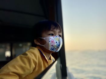 Portrait of asian boy with mark getting ferry, look away, hong kong