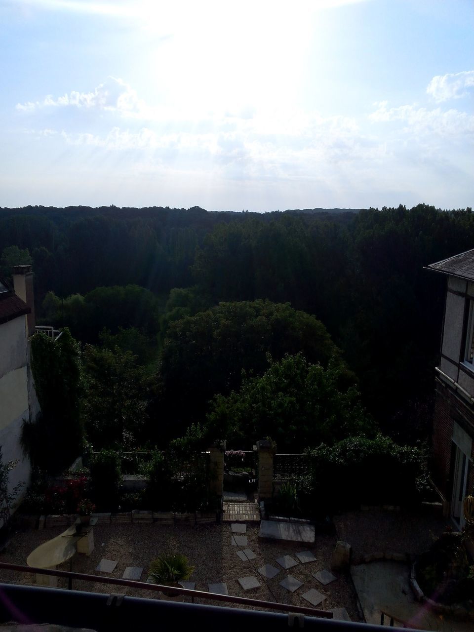 tree, built structure, architecture, sky, building exterior, mountain, growth, cloud - sky, nature, sunlight, house, plant, no people, day, cloud, railing, tranquility, high angle view, outdoors, beauty in nature