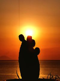 Silhouette tree against orange sky during sunset