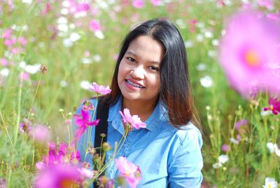Portrait of young woman with flowers