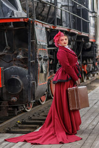 Rear view of woman standing in train