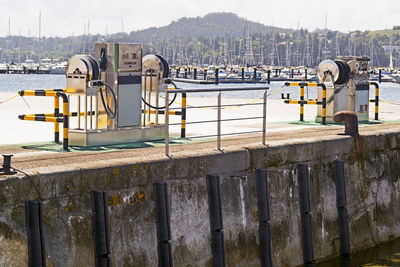 Wooden posts on river in city