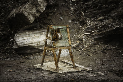 High angle view of abandoned chair on field