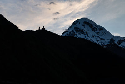 Scenic view of snowcapped mountains against sky during sunset