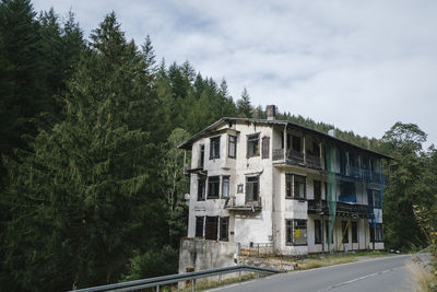 Road by building against sky