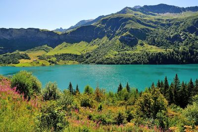 Scenic view of lake and mountains against sky