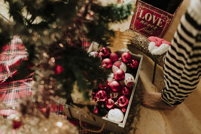 Man standing by christmas tree at home