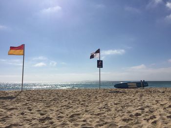 Lifeguard hut on beach against sky